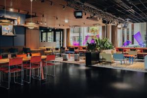 a restaurant with tables and chairs in a room at URBAN LOFT Cologne in Cologne
