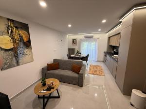 a living room with a couch and a table at ViA Lux Apartman in Pécs