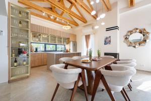 a kitchen and dining room with a wooden table and chairs at Villa Verdura in Budva