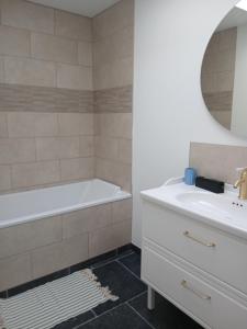 a bathroom with a white tub and a sink at Aux charmes flamands in Wemaers-Cappel +17 photos