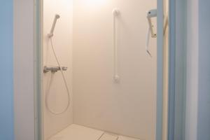 a shower in a bathroom with a glass door at Kaga Travel - Hakusandai, Whole building for rent in Kaga +34 photos