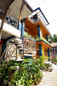 a house with a staircase in front of it at RAC's Inn Malumpati in Pandan