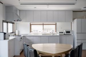 a kitchen with a wooden table and chairs in it at Kaga Travel - Hakusandai, Whole building for rent in Kaga