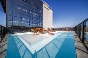 a swimming pool on the top of a building at Trade Hotel in Juiz de Fora