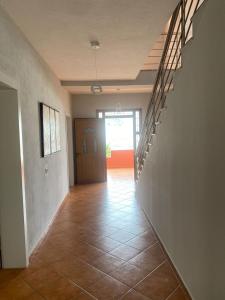 an empty hallway with a door and a tile floor at Marina View in Shëngjin