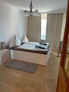 a bed with pillows on it in a room at Westblick in Plön