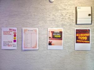 a wall with a bunch of posters on it at The Cubicle in Haldwāni