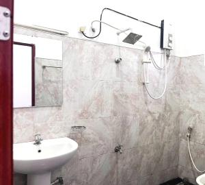 a bathroom with a sink and a shower at Mount View Hotel Badulla Room 02 in Badulla