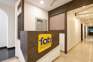 a lobby of aida hotels with a sign on a wall at FabHotel Happy in Vijayawāda