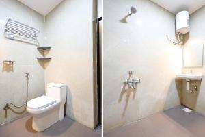 a bathroom with a toilet and a sink at FabHotel Happy in Vijayawāda +26 photos