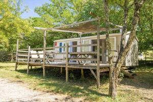 a tiny house with a gazebo next to a tree at Camping Sud Ardèche 3 étoiles familial piscine chauffée Gorges de l Ardèche Saint Remèze in Saint-Remèze
