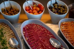 a table topped with bowls of different types of food at Glamping -420 in Kalia