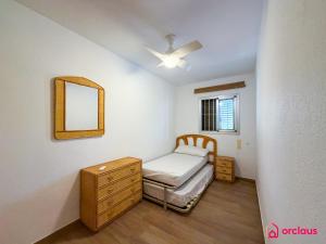 a bedroom with a bed and a dresser and a mirror at Bloom House in Oropesa del Mar +50 photos