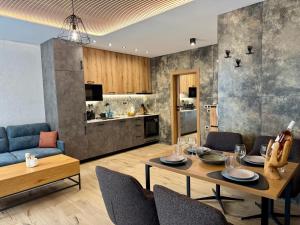 a dining room and kitchen with a table and chairs at Хотел Камъните in Burgas