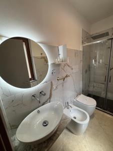 a bathroom with a sink and a toilet and a mirror at B&B Magliuolo in San Giovanni a Piro +37 photos
