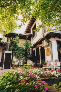 a building with a bunch of flowers in front of it at Oazis Family Hotel in Lovech