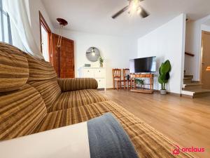 a bedroom with a bed and a living room at Bloom House in Oropesa del Mar