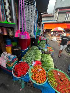 a market with baskets of fruits and vegetables on display at Cena Homestay in Rejeng