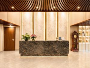 a lobby with a reception desk and a clock at Autumn Sea Boutique Hotel in Nha Trang