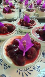 a table topped with plates of food with purple flowers at Sorres Agriturismo in Tanaunella
