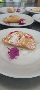 a white plate with a piece of food on a table at Sorres Agriturismo in Tanaunella