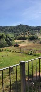 a field with a tractor in a field with a fence at Sorres Agriturismo in Tanaunella +5 photos