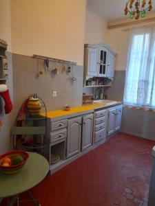 a kitchen with a sink and a table in it at Chambre Palais des Papes Avignon in Avignon