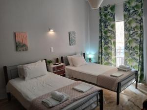a bedroom with two beds and a window at Αγγελικη in Kyparissia