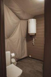 a bathroom with a toilet in a tent at Глемпінг Zatuшшя in Berezovka