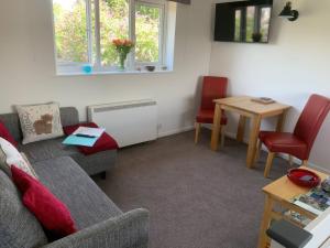 a living room with a couch and chairs and a table at Amber House in Dorchester