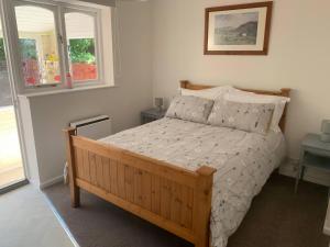 a bedroom with a bed and two windows at Amber House in Dorchester