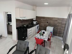 a kitchen with a table and chairs and a kitchen with white cabinets at Concordia, Entre Rios in Concordia