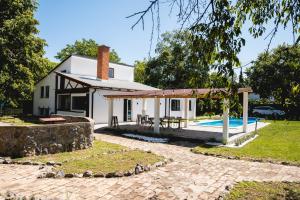 a house with a swimming pool in front of it at Vikendica Forest Mansion Surčin in Progar