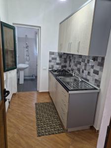 a kitchen with a sink and a stove top oven at Agron S in Vlorë