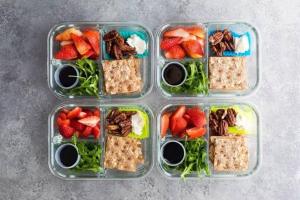 four plastic containers filled with food and fruits and vegetables at Giraffe Gallery Home in Arusha +19 photos