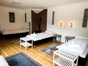 a living room with two beds and a table at Svingen Guesthouse - Panoramic Fjord Views in Flåm in Flåm +49 photos
