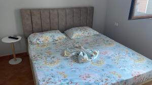 a stuffed animal is laying on a bed at Marina View in Shëngjin