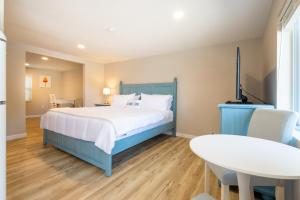 a bedroom with a bed and a table and chairs at Blue Lobster Inn Cape Cod in Yarmouth