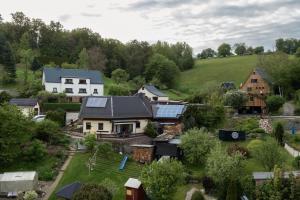 an aerial view of a house with solar panels on it at Ferienhaus Pöhlablick in Pöhla