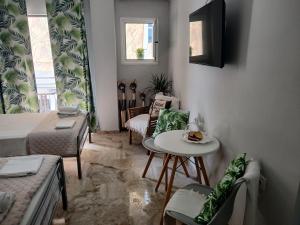 a living room with a bed and a table and a couch at Αγγελικη in Kyparissia