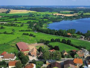 an aerial view of a small village with a lake at Ponyhof Naeve am Wittensee in Groß Wittensee