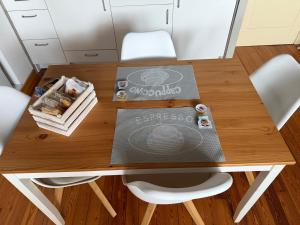a table with white chairs and a book on it at EDO'S HOME in Lonate Pozzolo