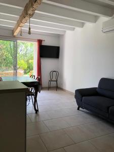 a living room with a ping pong table and a couch at Les Lilas piscine partagée in Les Vans