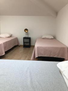 a room with two beds and a lamp in it at Les Lilas piscine partagée in Les Vans +22 photos