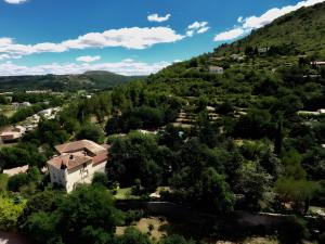 an aerial view of a village on a hill at Les Lilas piscine partagée in Les Vans