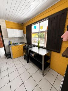 a kitchen with a table and a stove in it at Pousada da Maga in Fernando de Noronha