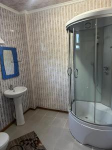 a bathroom with a shower and a sink at Достук in Bosteri