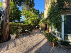 a patio with tables and chairs next to a building at Hotel Garni Picnic in Riccione