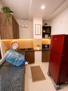 a kitchen with a plastic container on the counter at Family-Friendly Luxury Apartment Home Away From Home in Islamabad +7 photos