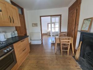 a kitchen and dining room with a table and a fireplace at No 23 in Kent